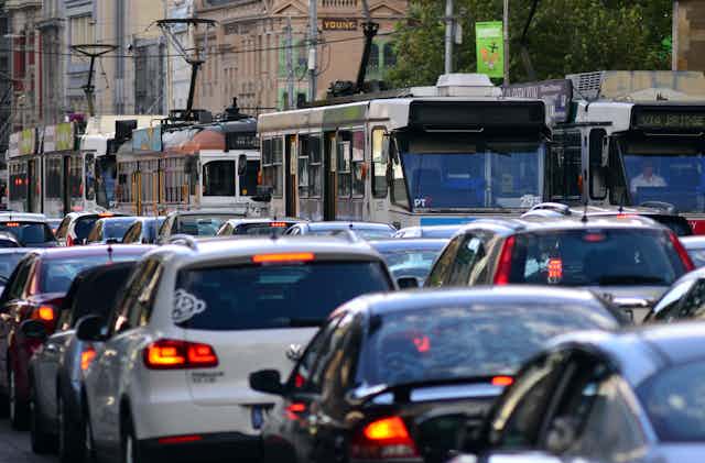 Cars and trams on a busy city street