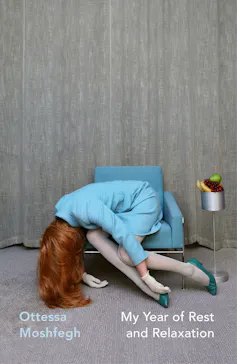 woman in pale blue suit slumped over a chair as if drugged