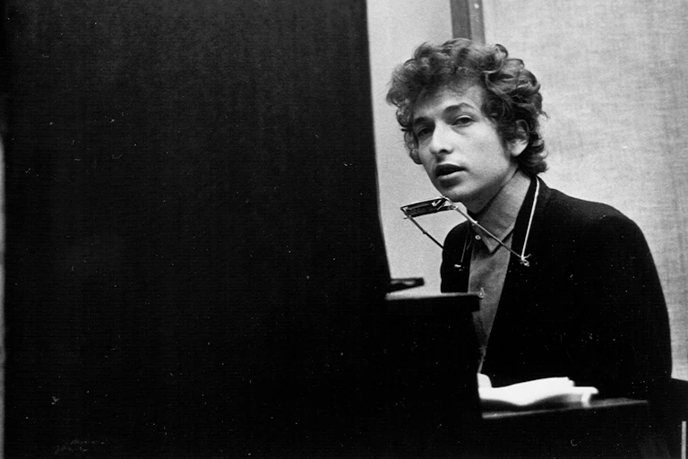 Young man sitting at a piano.