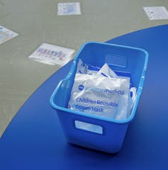 A box of masks seen on a school table.