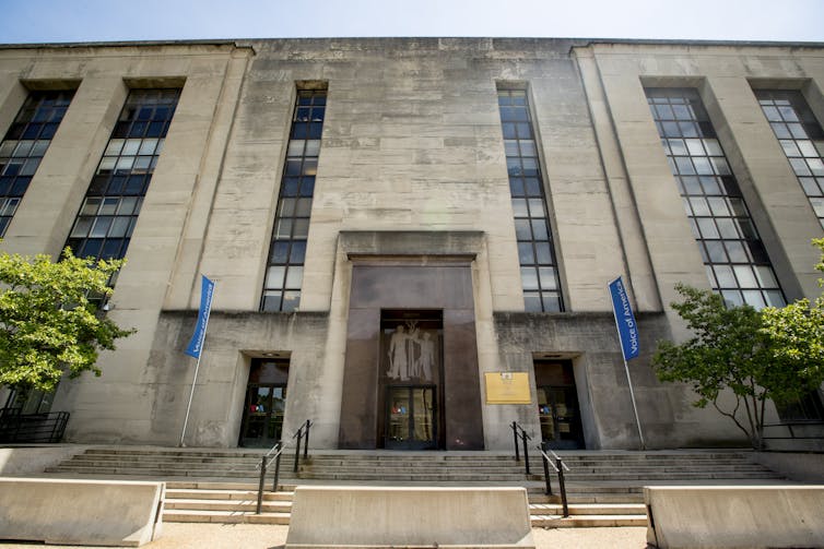 A large stone building with long vertical windows.