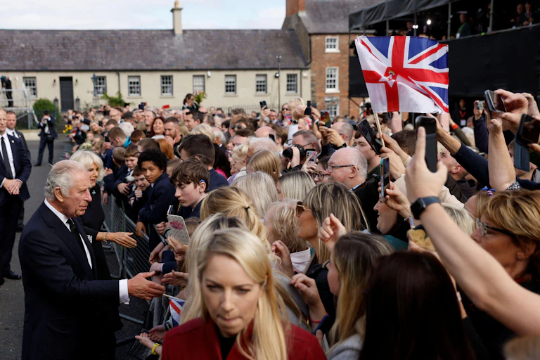 King Charles shaking hands with the public.