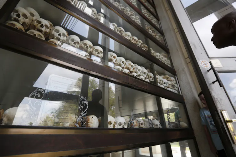 A tourist looks at a display with human skulls of victims who died during the Khmer Rouge regime at the Choeung Ek Genocidal Center on the outskirts of Phnom Penh in Cambodia.