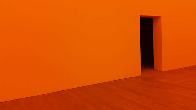 Orange wall, with door opening, orange floor