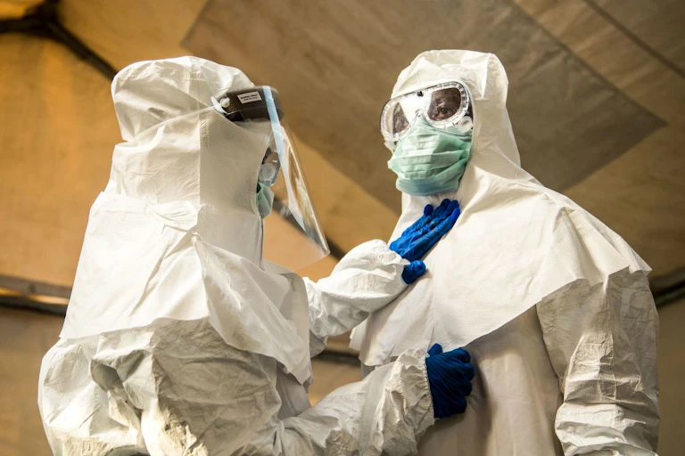 Two medical staff in protective suits