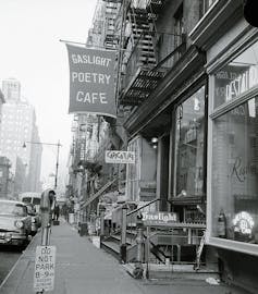 Image of New York City street with banner reading 'Gaslight Poetry Cafe.'