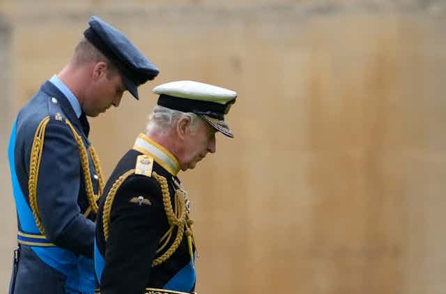 King Charles and Prince William dressed in military uniforms. 