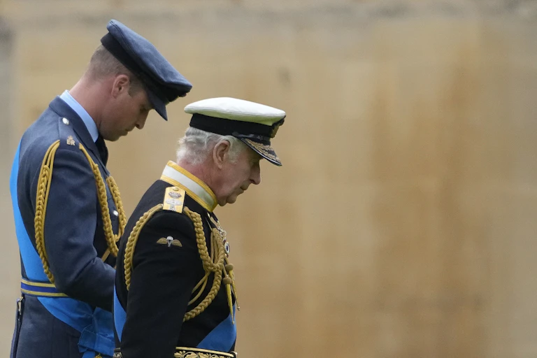 King Charles and Prince William dressed in military uniforms.