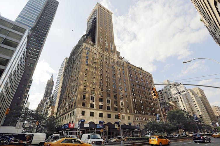 Vehicles pass the Trump Park Avenue building on a sunny day.