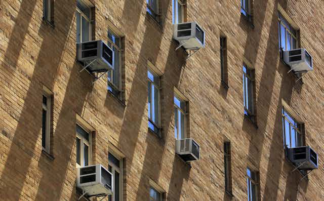 Window air conditioners on the side of a New York building.