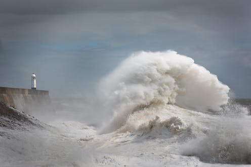 Storm Freya pounds the lighthouse at Porthcawl Point, in Brigend, Wales, on March 3 and 4, 2019.