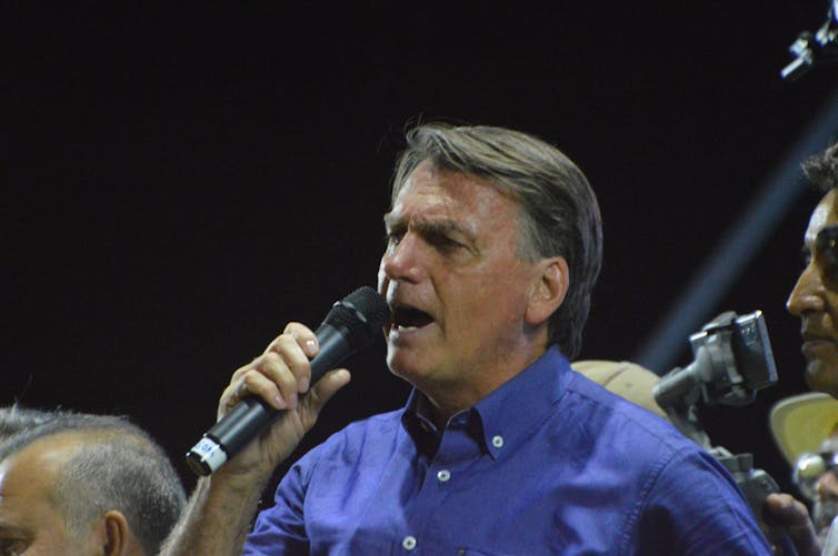 A man in a blue shirt.