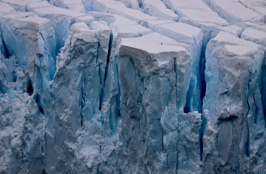 Ice breaking off the front of a glacier.