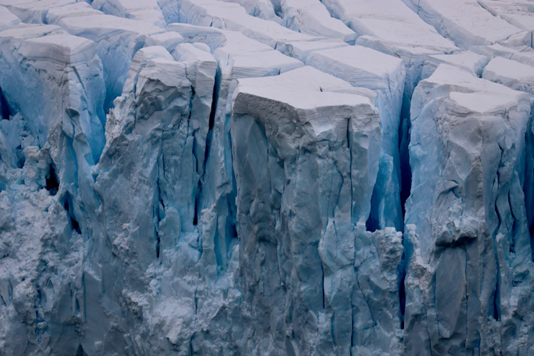 Ice breaking off the front of a glacier.