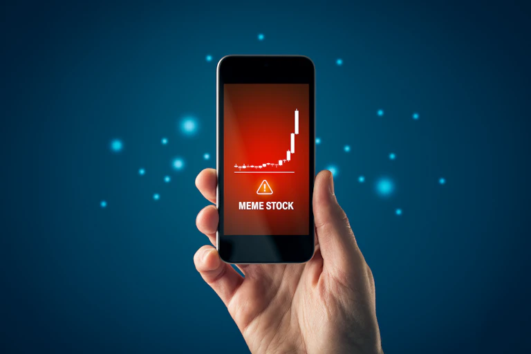 Hand holding iphone showing a meme stock rally.