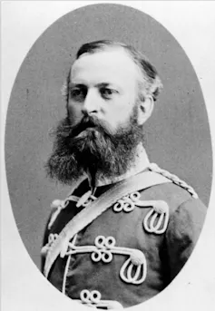 Black and white photo of a man seen in a military uniform.