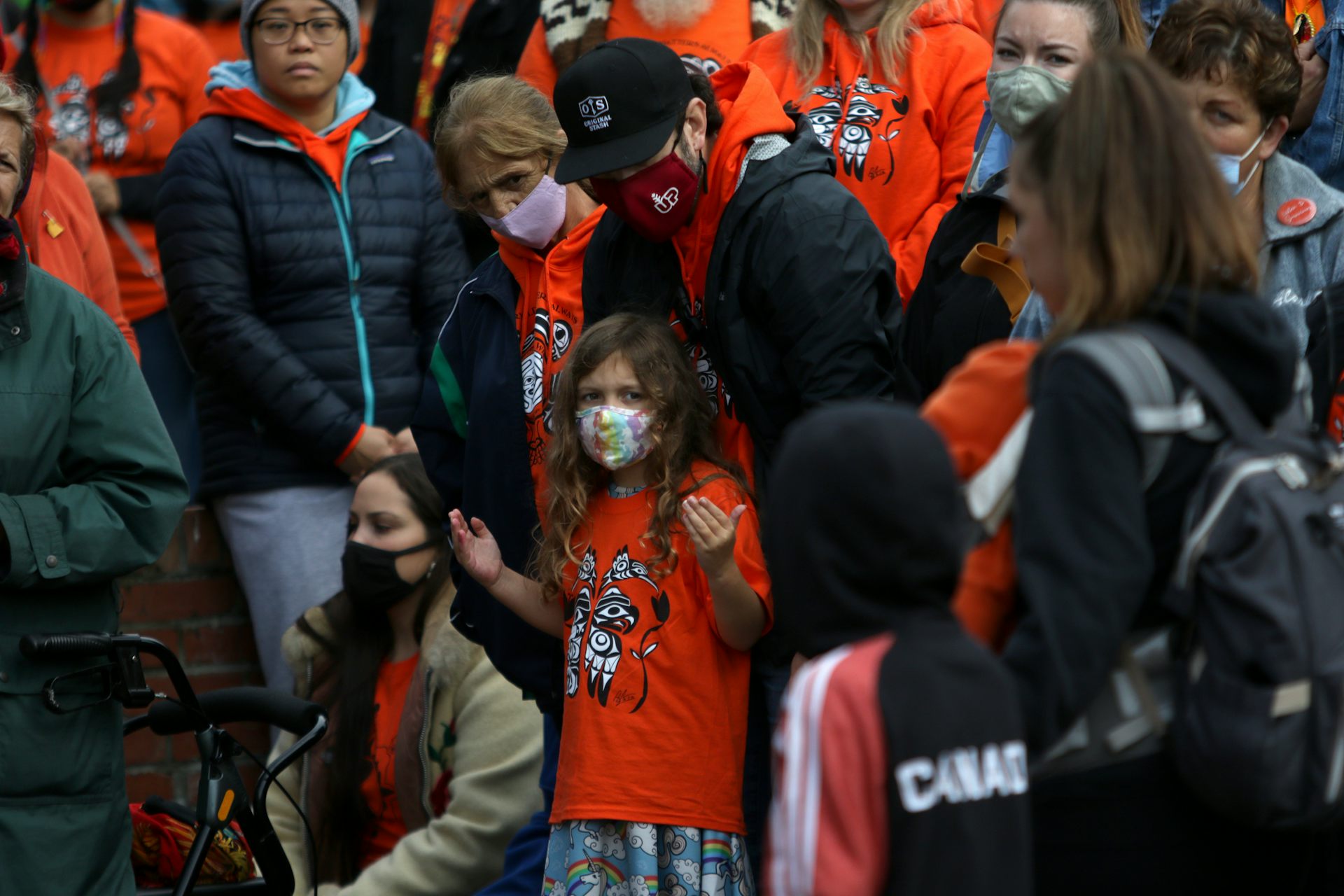 People attend a ceremony wearing orange shirts at Centennial Square in Victoria, B.C., Sept. 30, 2021. THE CANADIAN PRESS/Chad Hipolito