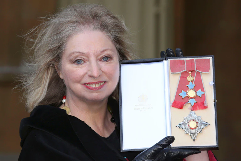 Dame Hilary Mantel dressed in black with her honour at Buckingham Palace.