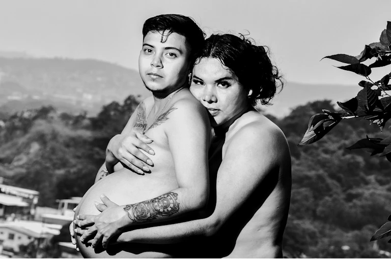 Diane Rodríguez hugging pregnant husband Zack Elias