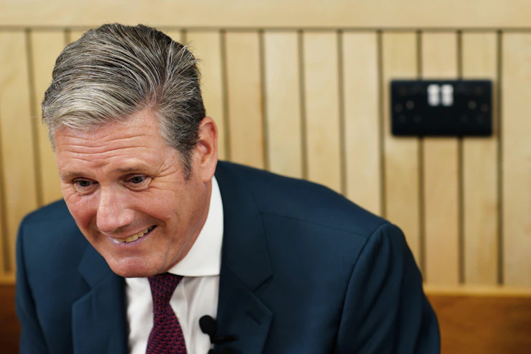 Keir Starmer smiling.