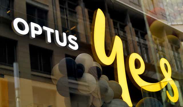 Signage of a glass-fronted shop that says OPTUS Yes