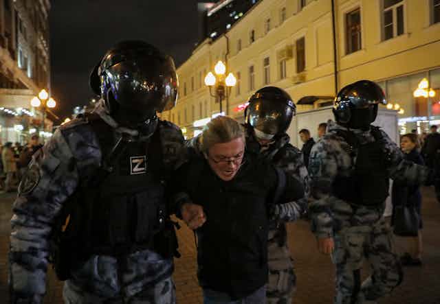 Russian police detain a protestor