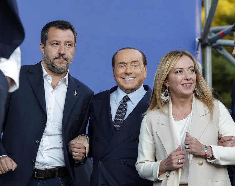 Matteo Salvini, Silvio Berlusconi and Gioriga Meloni pose together for a photo at a rally.