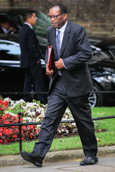 Kwasi Kwarteng walking with a red folder