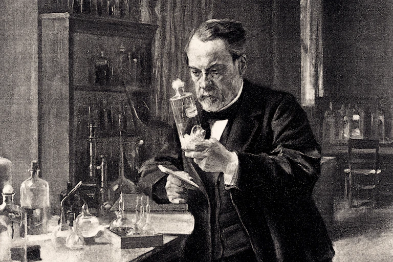 Standing next to a table covered by test tubes and beakers, Louis Pasteur holds a bottle partially filled with an unidentified liquid.