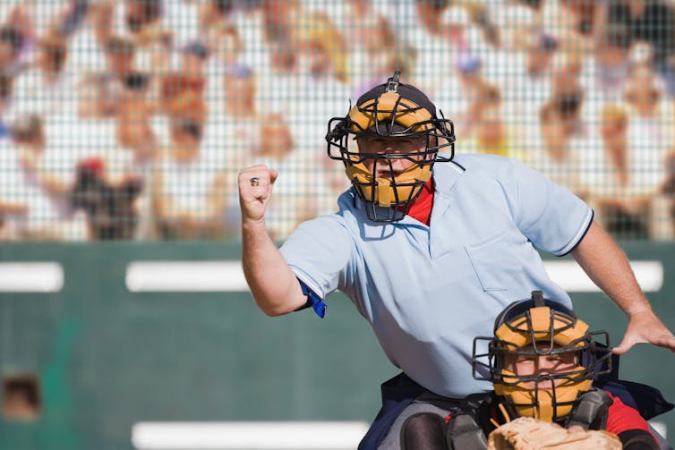 Umpire gesturing while calling a strike