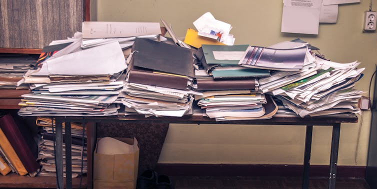 A table covered in stacks of documents
