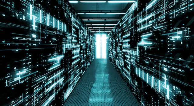 Digital image of server stacks lit with a teal light
