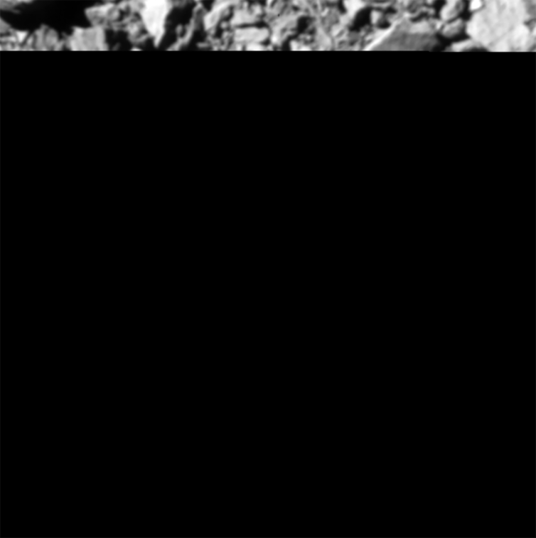 Rebanada de una imagen de superficie rocosa gris con el resto de la imagen en negro.