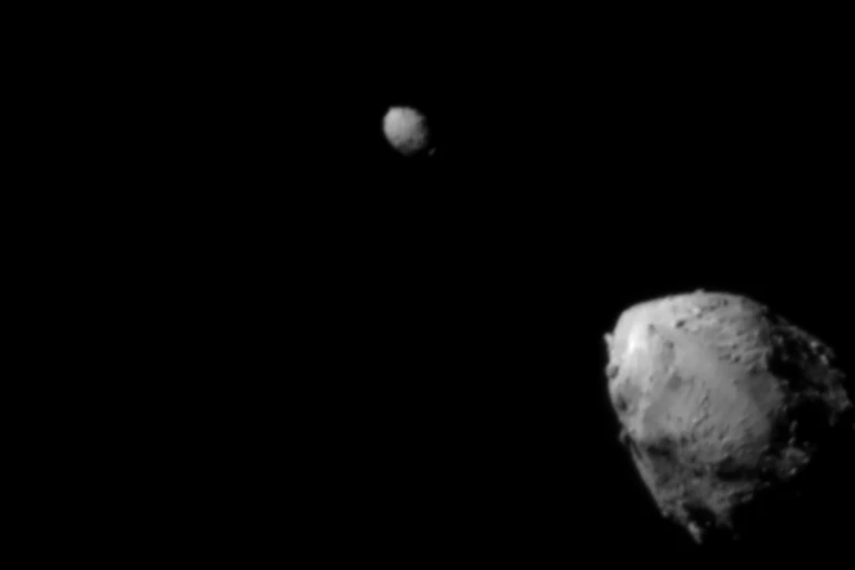Two gray rocks against the black backdrop of space.