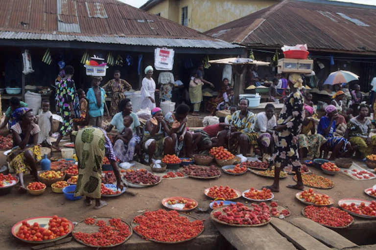 Women and their wares at an open market