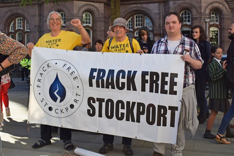 Protesters hold 'frack free Stockport' sign