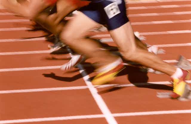 Close up of blurred sprinter legs on a track