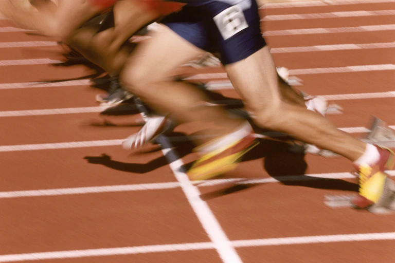 Close up of blurred sprinter legs on a track
