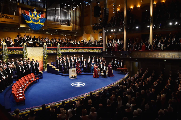 view of the Nobel Prize ceremony stage with people dressed in black tie