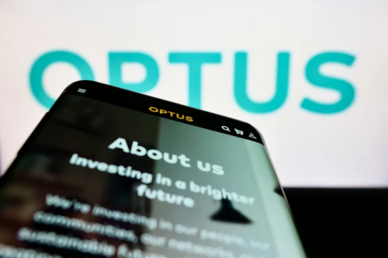Blue on white Optus logo with a smartphone screen in the foreground