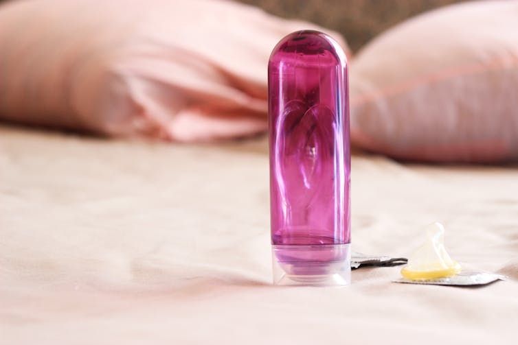 tube of lubricant on bed sheets