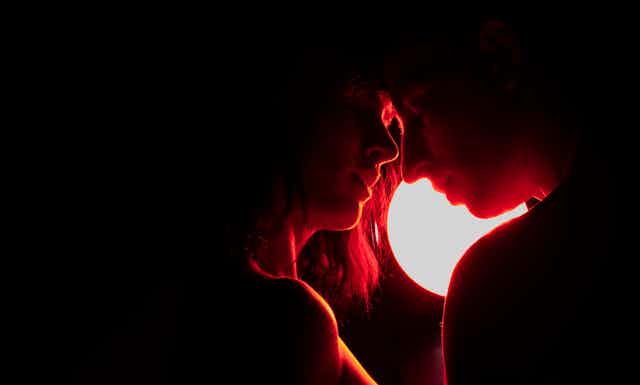 man and woman by red light