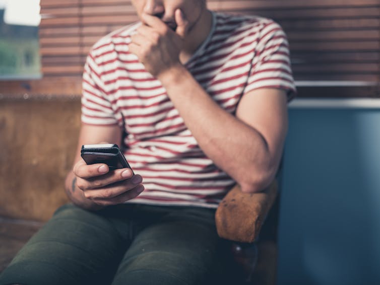 A man looks at his phone.