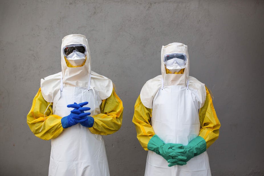 Staff from South Sudan's Health Ministry pose with protective suits during a drill for Ebola preparedness.