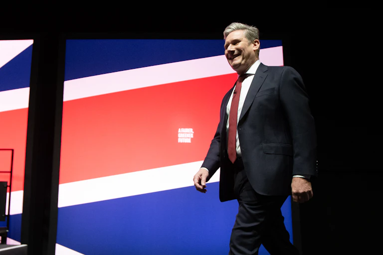 Man walks past flag