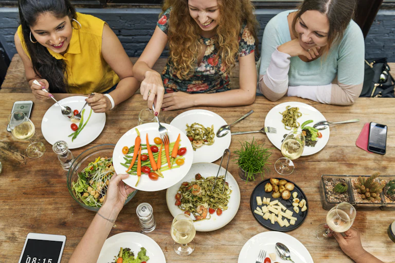 A group of young women eating healthy food at a restaurant.