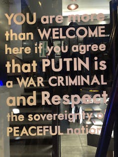 A sign in a restaurant in Tbilisi calling on Russian visitors to denounce the war in Ukraine.