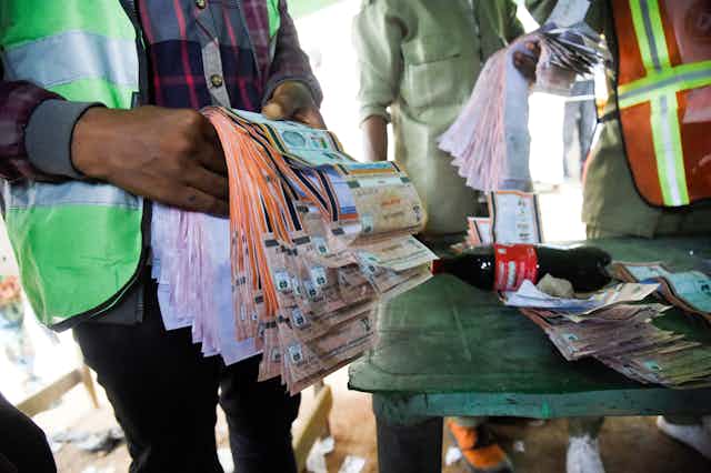An electoral official holds counted ballot papers at a polling station during the gubernatorial election at Ido Oshun, Osun State in southwest Nigeria, on July 16, 2022. 