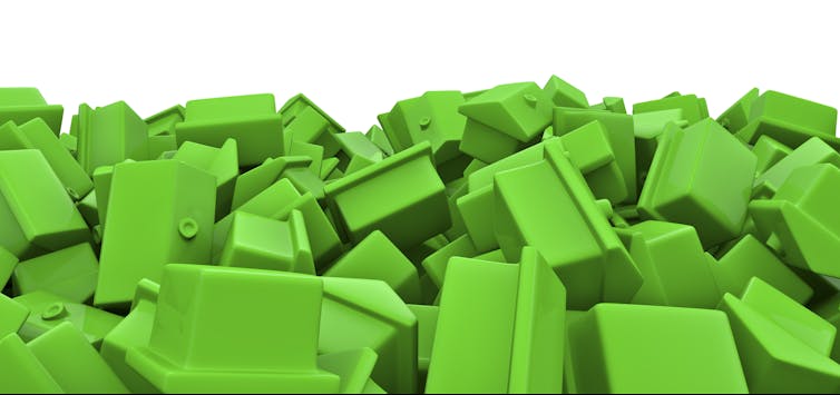 Messy pile of green toy houses.