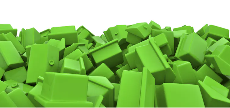 Jumbled pile of green toy houses.